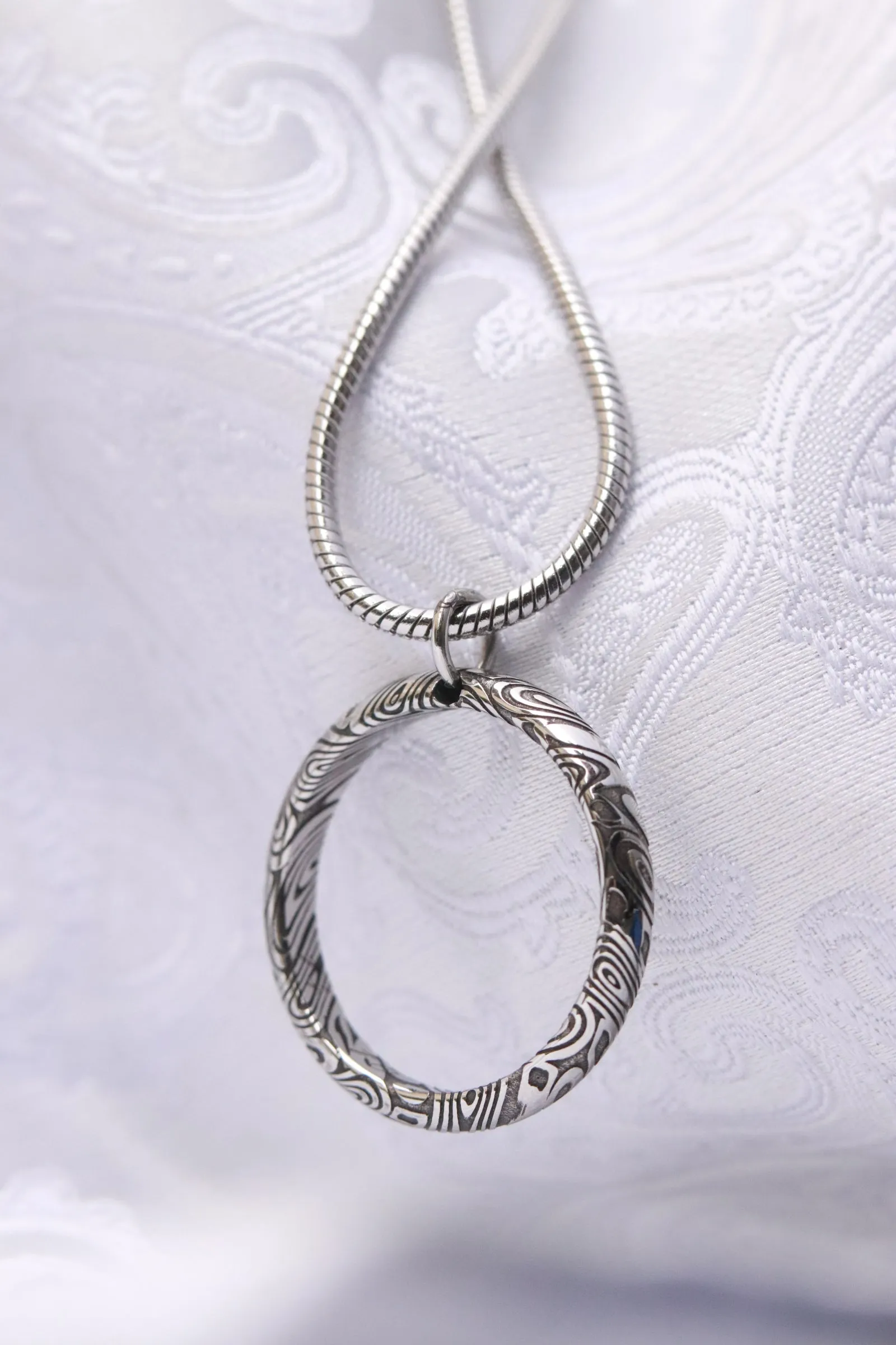 Necklace and ring style pendant damasteel