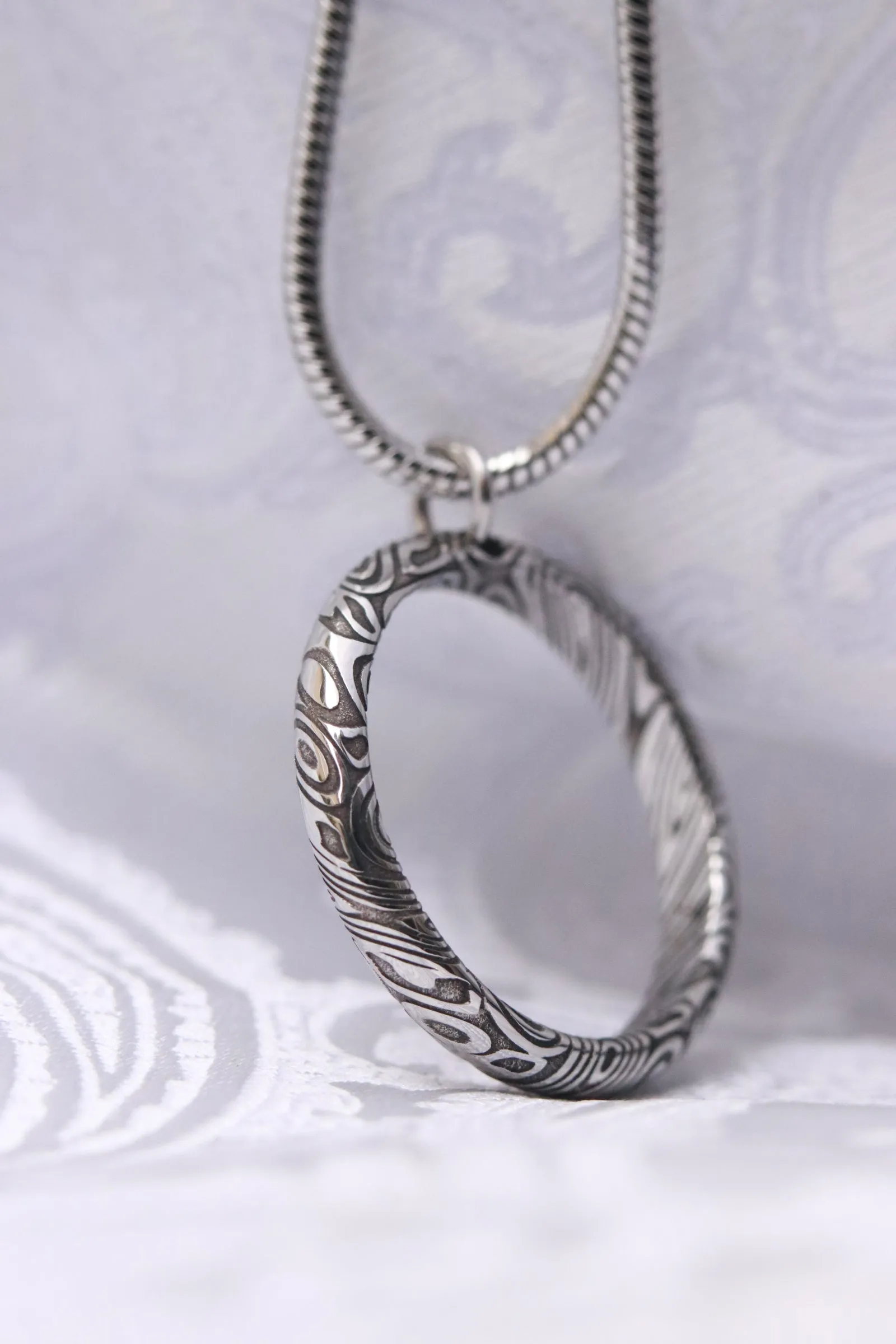Necklace and ring style pendant damasteel